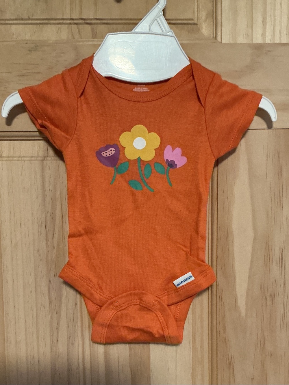 Orange Floral Baby Bodysuit by Onesies®